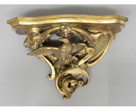 GILT GESSO WALL BRACKET, the serpentine shelf above an eagle amongst scolling foliage, height 40cm, width 52cm