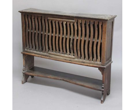 OAK FOOD HUTCH, including early woods, the front with wavy slats and a single door on a later base with shelf stretcher, heig