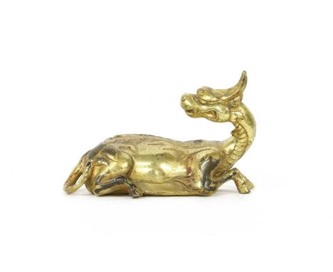 A Chinese bronze qilin, the recumbent beast with it's head turned to the back, 15.5cm long