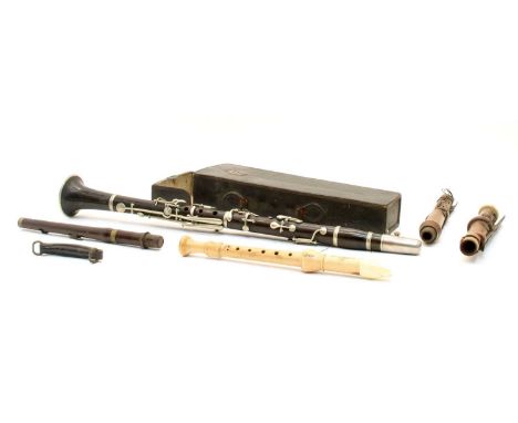 A 19th century ebony clarinet, stamped 'W. Carol Maker, 42 Maddox Street, London, W', with nickel plated mounts, in a black l