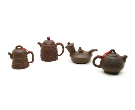 A collection of four Chinese Yixing zisha teapots, 20th century, comprising: one of globular form on bracket feet with incise