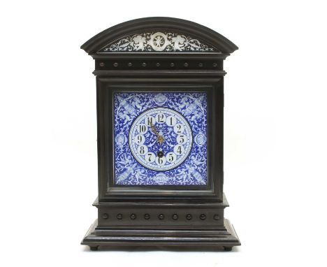 A late 19th century Continental Aesthetic period ebonised cased mantle timepiece, with blue and white enamel dial, 29cm wide,