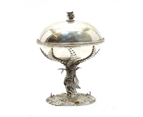 An electroplated bonbonniere in the form of an egg, early 20th century, supported by foliage, on a naturalistic base, 17.5cm 
