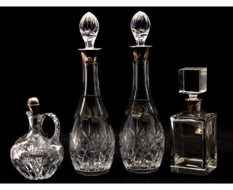 Four silver mounted glass decanters and stoppers, comprising: a cut glass pair, by Charles S Green &amp; Co. Birmingham 1971,