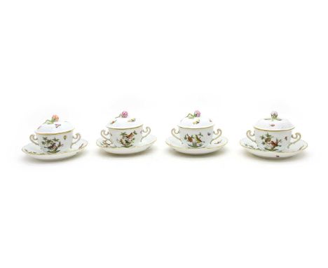 A set of eight Herend porcelain chocolate cups, covers and saucers in the 'Rothschild' pattern, each with a floral finial and