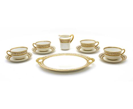 An early 20th century Haviland tea service for eleven, comprising of twelve cups, eleven saucers, eleven tea plates, cream ju