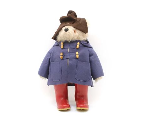 A 1970s plush Paddington Bear figure, with brown felt hat, blue duffel coat and red Dunlop Wellington boots, 48cm high (exclu