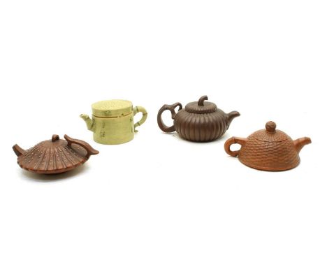 A collection of four Chinese Yixing zisha teapots, 20th century, comprising: one of melon form, decorated with applied chrysa