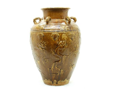 A Chinese martaban jar, with moulded dragons and cranes, under a band of florets, the shoulder with loop ring handles, all un