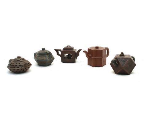 A collection of five Chinese Yixing zisha teapots, 20th century, comprising: one of compressed form, carbon pierced, 15cm lon