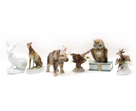 A collection of Hungarian Zsolnay Pecs porcelain figures, to include an owl atop a book, 27cm high, a figure of a hound, 25.5