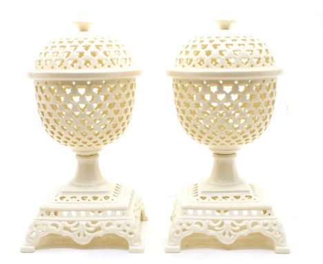 A pair of modern pierced creamware lidded urns, with decorative square bases, 37cm highCondition report: No damage, light sur