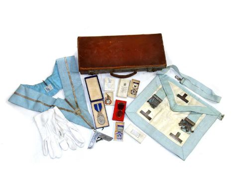 A collection of Masonic items, to include apron, sash, a pair of white gloves, a silver gilt and enamel 'Royal Masonic Instit