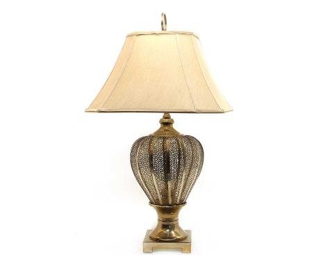 A Middle Eastern style table lamp, with pierced metal base and cream shade, 82cm high