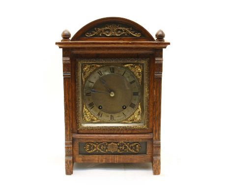 An early 20th century oak cased bracket clock, the eight day gong strike movement with quarter chime and arched dial with Rom
