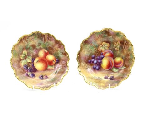 A pair of Royal Worcester hand-painted and gilt heightened cabinet plates, 20th century, by H.H. Price, decorated with plums,