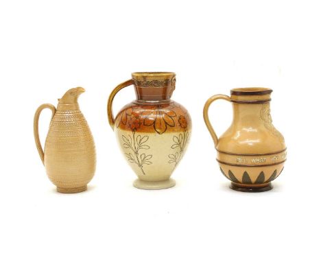 Three Doulton Lambeth stoneware jugs, one with a large mask and band inscribed 'Fill what you will, and drink what you fill',