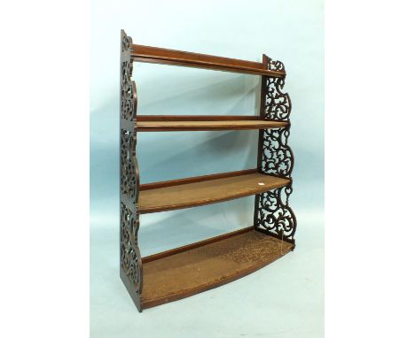 A mahogany four-tier hanging display shelf, each bowed shelf within pierced fret sides, 86cm high, 75cm wide, a Georgian tray