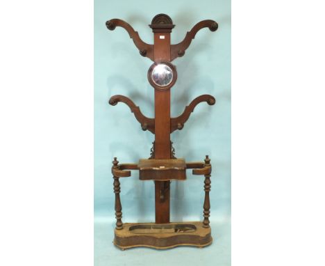 A Victorian mahogany four-branch hall stand, with central circular mirror above a glove box and stick stand, 196cm high.