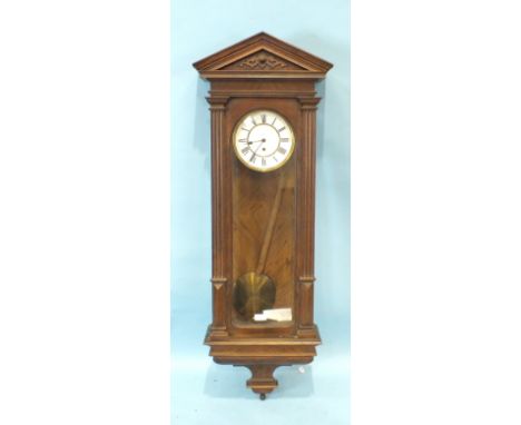 A walnut Vienna-style wall clock with single weight and pendulum, two-piece enamel dial and key-wind movement, 128cm high.