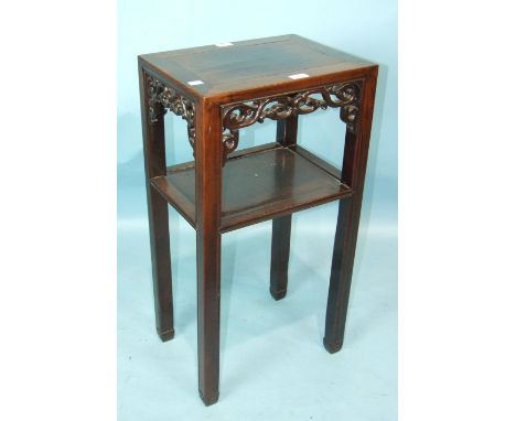 A 19th century Chinese hardwood plant stand, the rectangular panelled top with pierced apron above a shelf on square moulded 