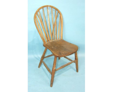 An elm stick back chair with solid seat on shaped turned legs and stretchers, (possibly Yealmpton).