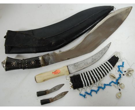 An Eastern kukri in leather scabbard; together with a Far Eastern jambiya (2)