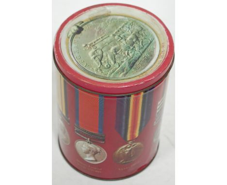 A modern biscuit tin, lithograph printed with various campaign medals