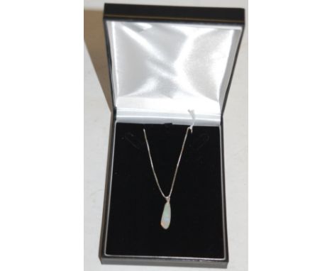 A polished opal pendant on finelink neck chain 