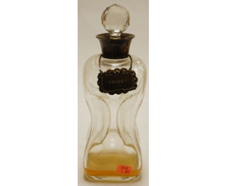 A late Victorian glass decanter of hourglass form, having silver collar and whisky label