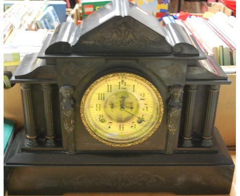 A large Victorian black slate mantel clock of architectural form having a matt dial with Arabic numerals and eight day moveme