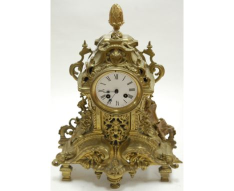 A French brass cased mantel clock having an enamelled dial with Arabic numerals, cylinder movement, and striking on a bell