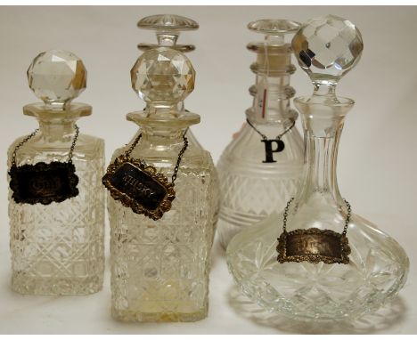 A  pair of Regency cut glass triple ring neck decanters together with one other pair of cut glass decanters and stoppers, and