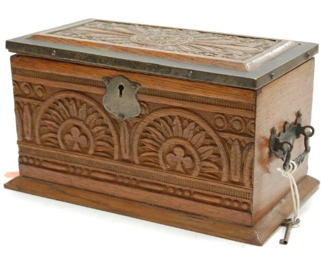 A late Victorian carved oak tea caddy with silver plated mounts (with key)