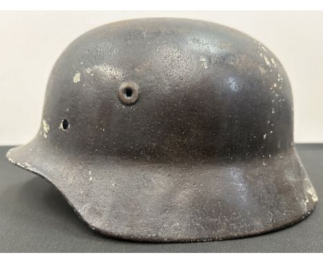 WW2 Third Reich M40 Pattern Steel Helmet battle damaged Normady relic. Shrapnel damage to the visor and distorted. Previously