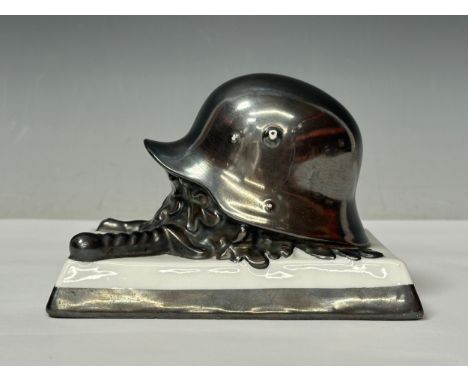 WW2 Third Reich Desk Ornament of an M16 steel helmet with Crossed Swords and Oakleaves by Rosenthal of Bavaria. Length 13cm a