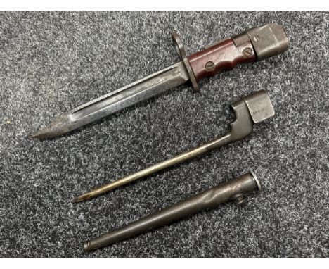 British No 7 MK I /1. Land Service Bayonet with fullered Bowie style blade 196mm in length. Maker marked"P 1948". Red composi