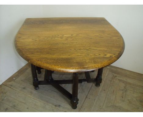 1930's oak drop leaf table on turned supports