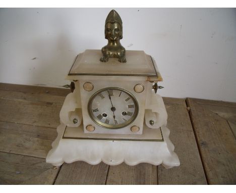 Alabaster cased mantle clock with brass mounts and figure of a sphinx with striking movements