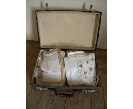 Vintage suitcase with a large selection of various assorted linen