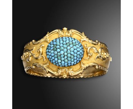 A Victorian turquoise-set gold hinged bangle, the oval bombé plaque is pavé-set with cabochon turquoise within gold scrolling