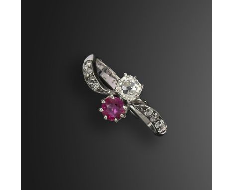 A ruby and diamond crossover ring, set with a circular-cut ruby and an old cushion-shaped diamond, with further old circular-