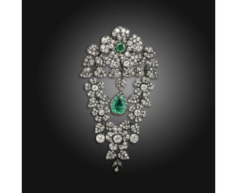 A diamond and emerald corsage brooch, the wild rose design centred with a circular-cut emerald and pavй-set with graduated ci