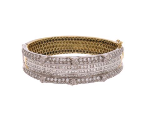 A diamond-set gold bangle, set with princess-cut and round brilliant-cut diamonds in white and yellow gold, 5.8cm inner diame