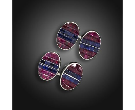 A pair of ruby and sapphire cufflinks, the oval links are centred with two lines of rectangular-cut sapphires and further cal