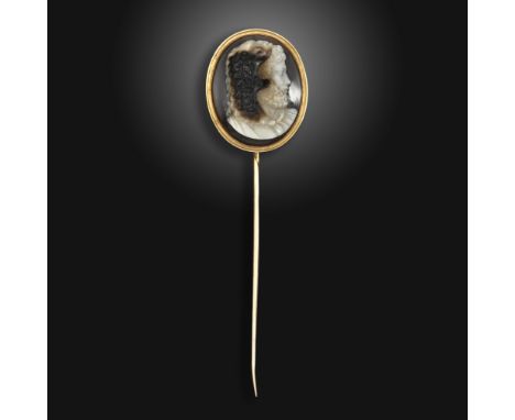 A 19th century sardonyx cameo-mounted gold stick pin, the cameo depicting Hercules wearing the Nemean lion skin, with foliate