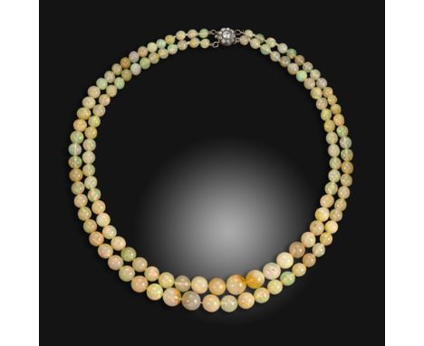 A two row opal bead necklace, the opals graduate from 5.0 - 10.0mm, with a gold and diamond cluster clasp, 45cm long