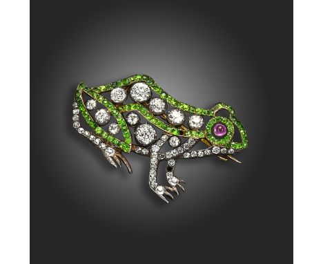 An early 20th century frog brooch, set with graduated old circular-cut diamonds and lines of demantoid garnets, with cabochon