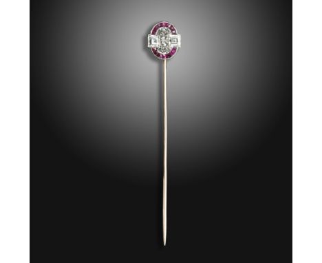 A ruby and diamond stickpin by Van Cleef &amp; Arpels, the oval plaque millegrain-set with tapered calibré-cut rubies and two