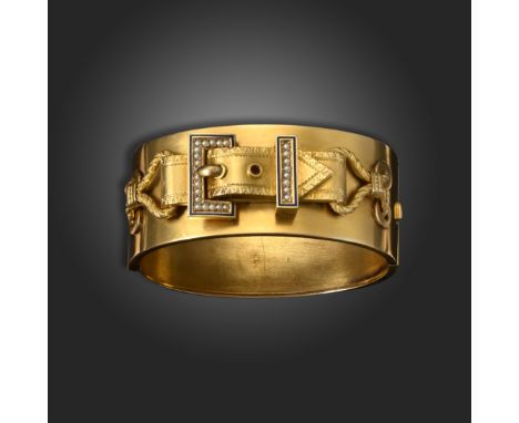 A Victorian gold hinged bangle, with stylised gold buckle decoration set with seed pearls in a blue enamel border, 5.5cm inne